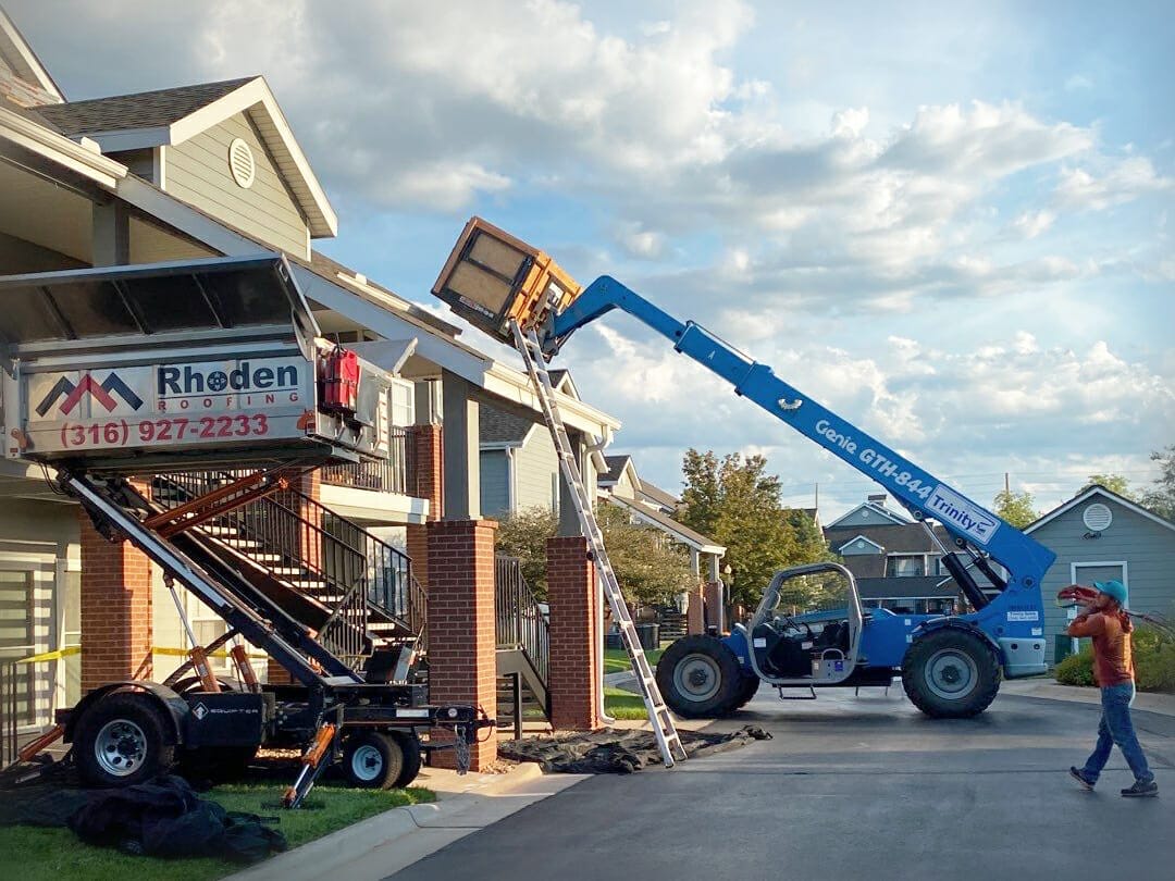 Hydraulic Lift Trailer and Telehandler Equipment in use on Multifamily Apartment Roofing Project - Rhoden Roofing